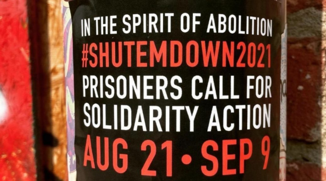 A sticker announcing "In The Spirit of Abolition | #SHUTEMDOWN2021 | Prisoners Call For Solidarity Action | Aug 21-Sep 9"